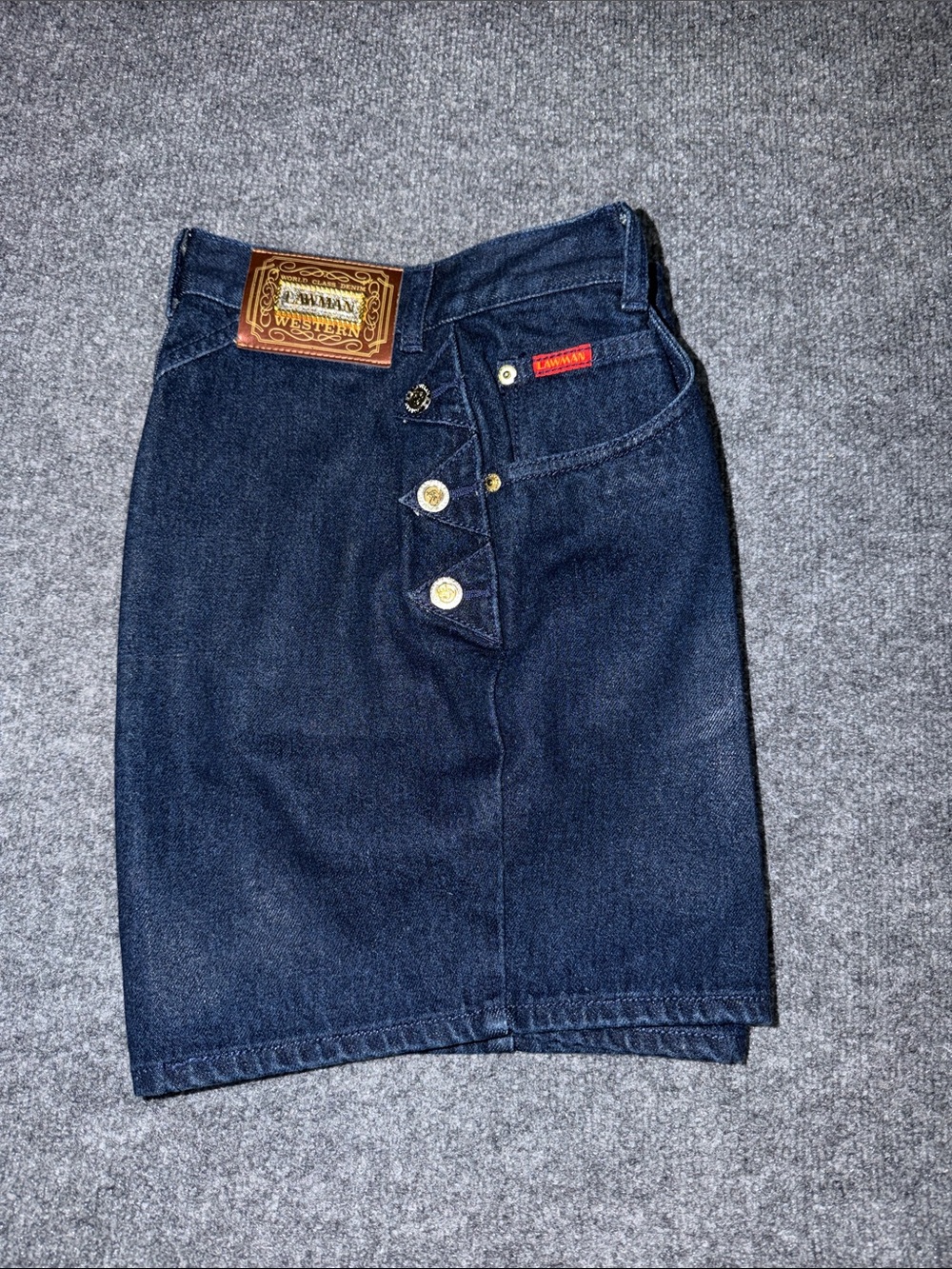 vintage Lawman high-waisted dark wash denim shorts featuring prominent gold-tone